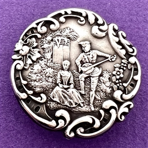 Hallmarked silver button of man serenading a woman in a garden.