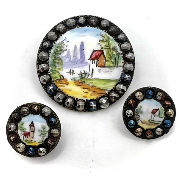 Three painted enamel buttons of architectural scenes.