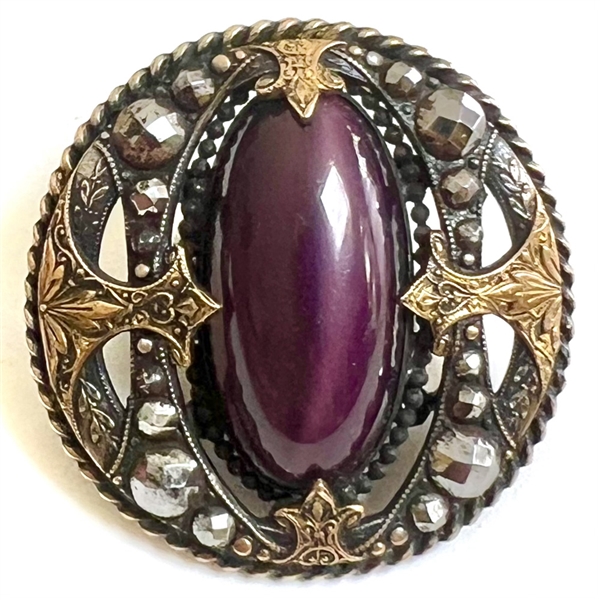 True gay 90s button with oval glass center and unique mounting.