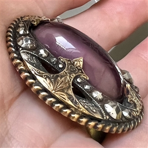 True gay 90's button with oval glass center and unique mounting.