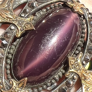 True gay 90's button with oval glass center and unique mounting.