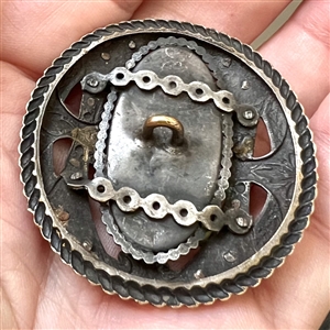 True gay 90's button with oval glass center and unique mounting.