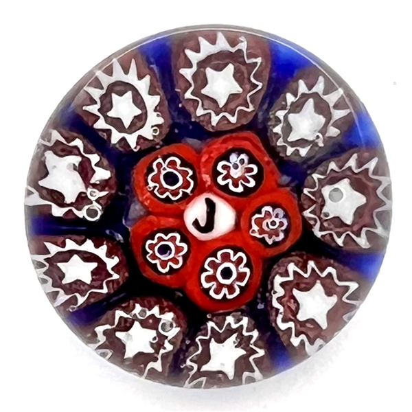 Glass paperweight studio button with verbal by John Gooderham with cane elements.