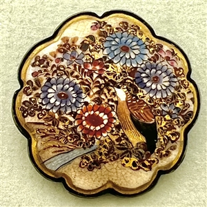 Japanese Satsuma button of a bird among flowers set in silver with a scalloped border.