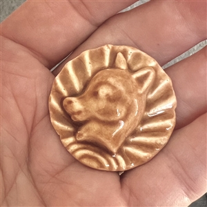 Ceramic button of a young donkey's head.