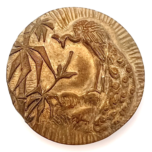 Brass button of a peacock near bamboo.