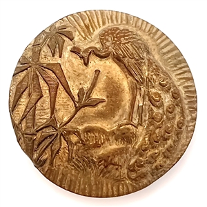 Brass button of a peacock near bamboo.