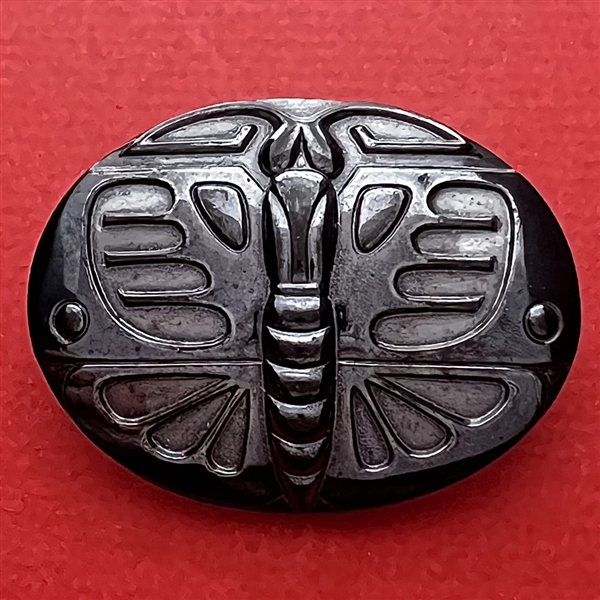 Large black glass button of a butterfly