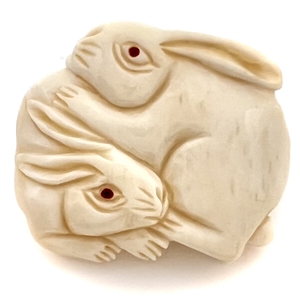 White rabbits natural material button carved in the netsuke style. 