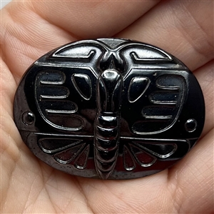 Large black glass button of a butterfly