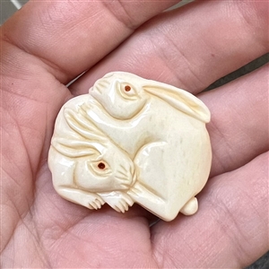 White rabbits natural material button carved in the netsuke style. 