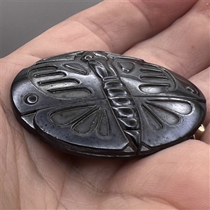 Large black glass button of a butterfly