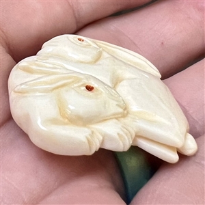 White rabbits natural material button carved in the netsuke style. 
