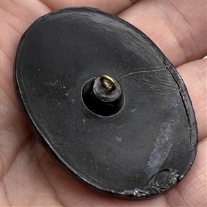 Large black glass button of a butterfly