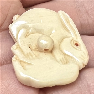 White rabbits natural material button carved in the netsuke style. 