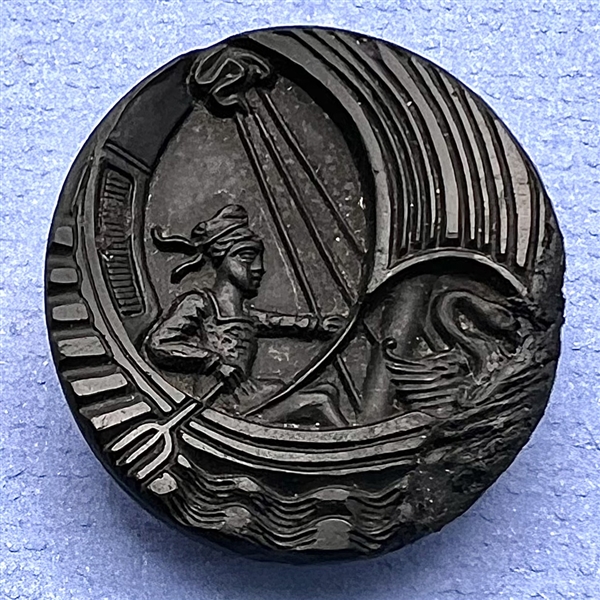 Black glass button of boy in a swan boat.