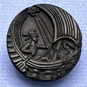 Black glass button of boy in a swan boat.