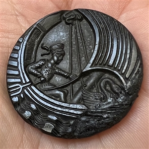 Black glass button of boy in a swan boat.