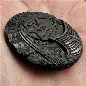 Black glass button of boy in a swan boat.