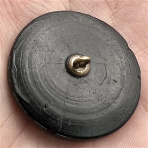 Black glass button of boy in a swan boat.