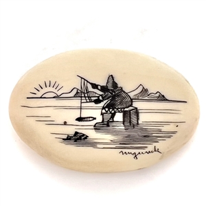 Scrimshaw button of an Eskimo ice fishing.