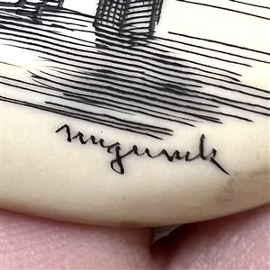 Scrimshaw button of an Eskimo ice fishing.