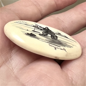 Scrimshaw button of an Eskimo ice fishing.
