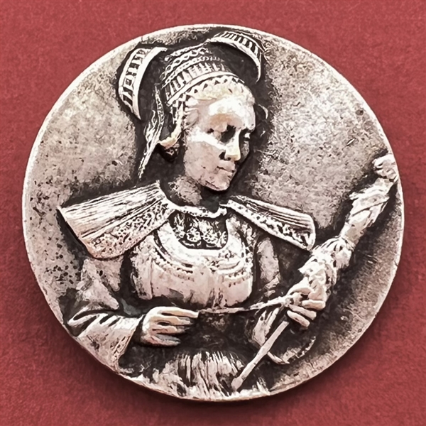 Stamped white metal button of a woman in provincial costume 