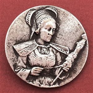 Stamped white metal button of a woman in provincial costume 