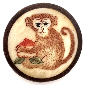 Natural material button of a monkey with a turnip set in boxwood.