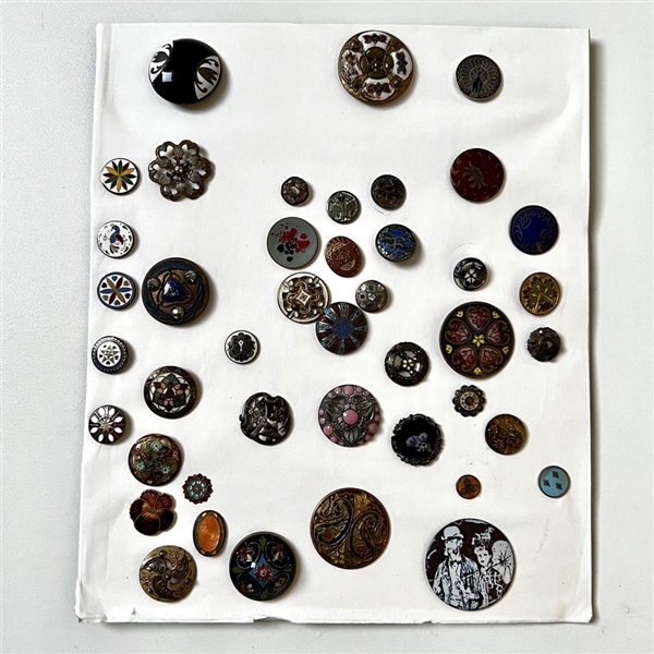 Card of forty four mostly enamel buttons.