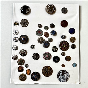 Card of forty four mostly enamel buttons.