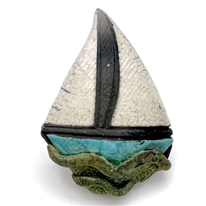 Ceramic studio button of a sail boat.