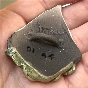 Ceramic studio button of a sail boat.