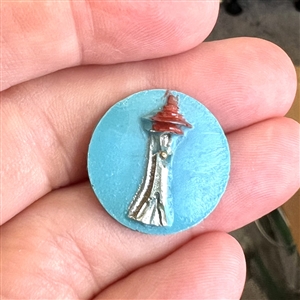 Plastic button of the Space Needle from the 1962 World's Fair in Seattle.