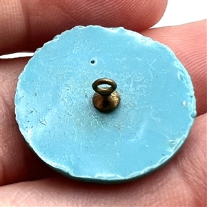 Plastic button of the Space Needle from the 1962 World's Fair in Seattle.