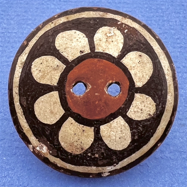 Zia pueblo button of a flower.