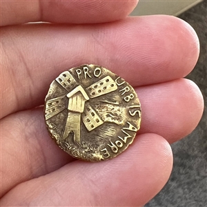 Brass stud of a windmill and “Pro Urb is Amore.