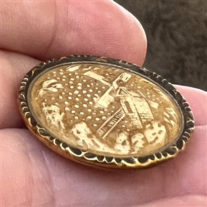 Ivoroid button of windmill with brass rim. 