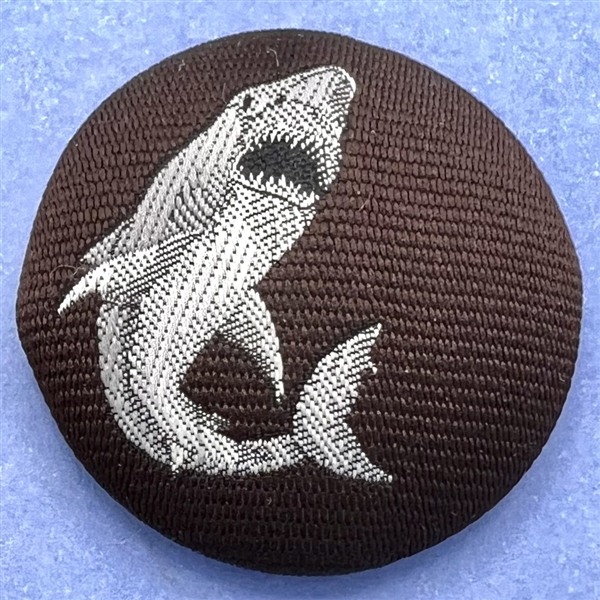 Fabric button of a shark.