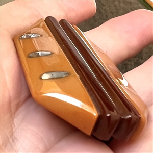 Laminated Vintage Bakelite button with metal inlays.