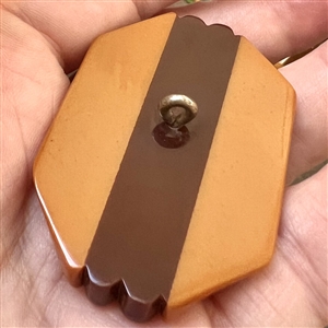 Laminated Vintage Bakelite button with metal inlays.