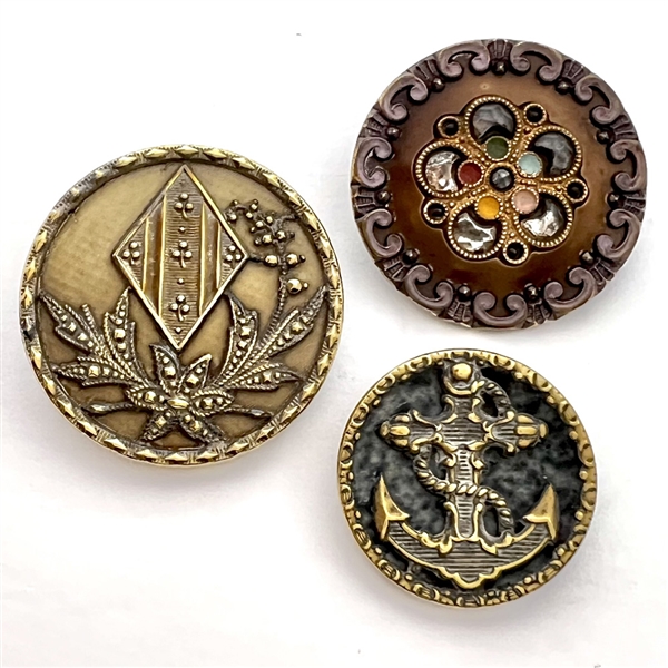 Three Victorian celluloid buttons.
