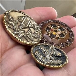 Three Victorian celluloid buttons.