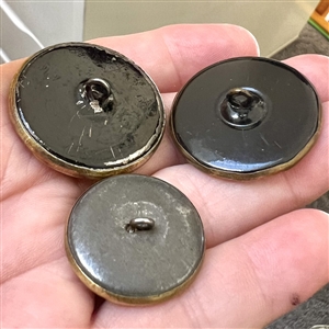 Three Victorian celluloid buttons.