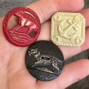 Three buffed Vintage celluloid buttons. 