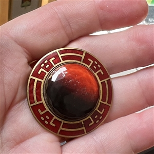 Ombre black/red faceted glass in metal with enamel border.