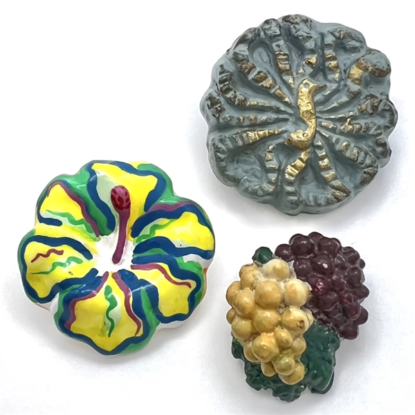 Three plaster buttons, peacock etc…