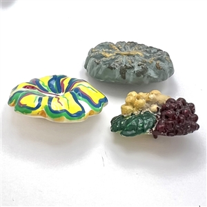 Three plaster buttons, peacock etc…