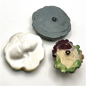 Three plaster buttons, peacock etc…